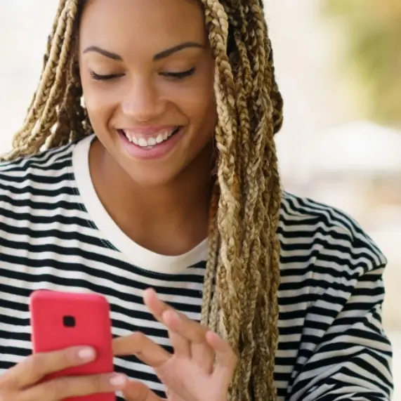 woman looking at phone smiling
